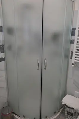 a shower with white cabinets in a bathroom at Casa Giovanna in Rome