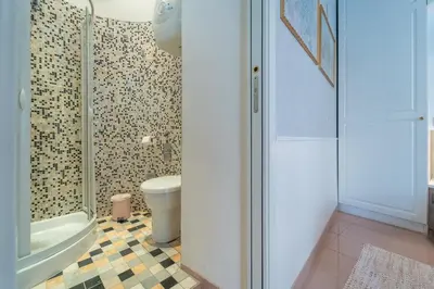 a bathroom with a toilet and a glass shower at Secret Studio Retreat in the Heart of the Ghetto by Houseeds in Rome