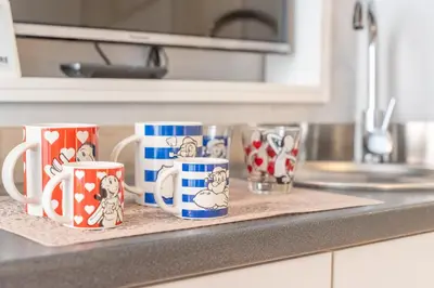 a group of mugs sitting on a kitchen counter at Secret Studio Retreat in the Heart of the Ghetto by Houseeds in Rome