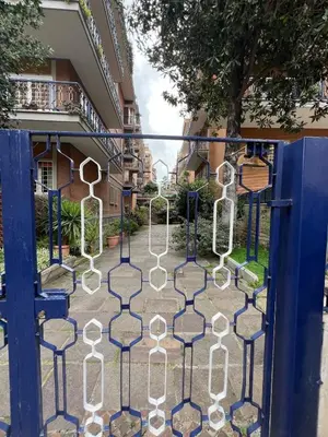 a gate to a building with white sculptures on it at Casa Vale in Rome