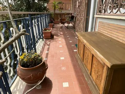 a porch with a wooden bench and a potted plant at Casa Vale in Rome