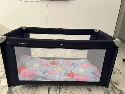 a crib with a hello kitty blanket on it at Casa Vale in Rome