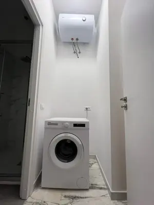 a washer and dryer in a white room with a wall at Casa Vale in Rome
