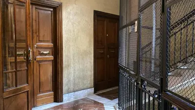 an empty room with a gate and a door at Charming Apartment in San Pietro in Rome