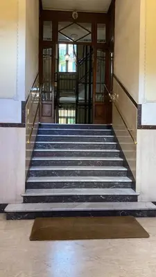 a staircase leading to a building with a glass door at Charming Apartment in San Pietro in Rome