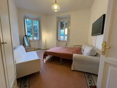 a living room with a bed and a couch at Charming Apartment in San Pietro in Rome