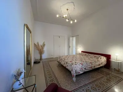 a bedroom with a large bed and a mirror at Charming Apartment in San Pietro in Rome