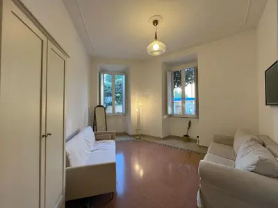 a living room with two white couches and two windows at Charming Apartment in San Pietro in Rome