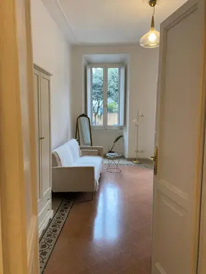 a living room with a couch and a window at Charming Apartment in San Pietro in Rome