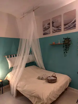a bedroom with a canopy bed with a basket on it at Colosseum Studio Flat blue in Rome