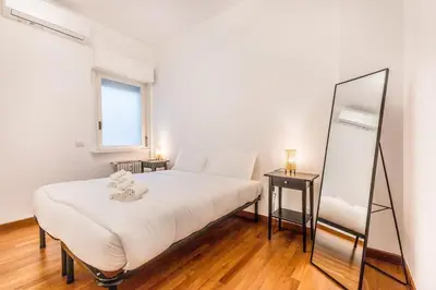 a bedroom with a large bed and a mirror at Zampieri Loft in Rome