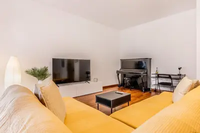 a living room with a couch and a flat screen tv at Zampieri Loft in Rome