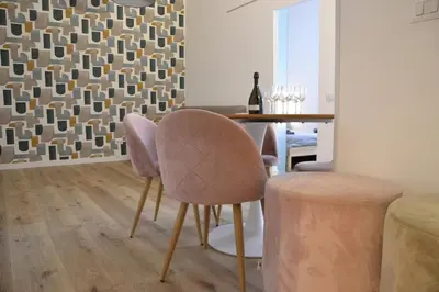 a dining room with a table and a chair at Il Rifugio dell Inventore in Rome