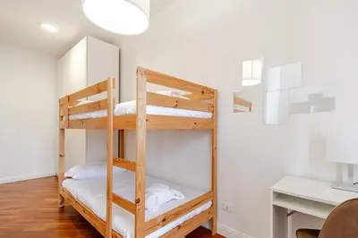 a bedroom with two bunk beds in a room at Luminoso Attico Piazza Bologna - Metro Policlinico in Rome