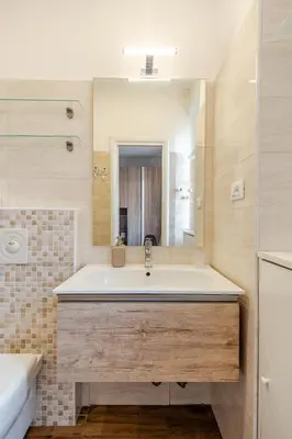 a bathroom with a large white tub and a sink at Luminoso Attico Piazza Bologna - Metro Policlinico in Rome