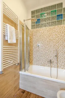 a bathroom with a tub and a shower and a sink at Luminoso Attico Piazza Bologna - Metro Policlinico in Rome