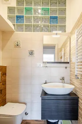 a bathroom with a sink and a toilet at Luminoso Attico Piazza Bologna - Metro Policlinico in Rome