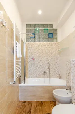 a bathroom with a tub and a toilet and a sink at Luminoso Attico Piazza Bologna - Metro Policlinico in Rome