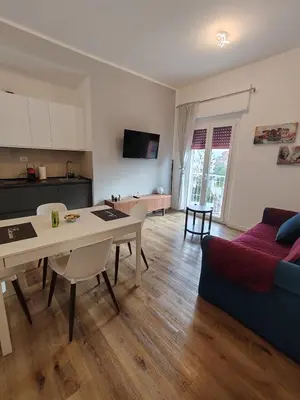 a kitchen and living room with a table and a couch at Domus MT481 in Rome