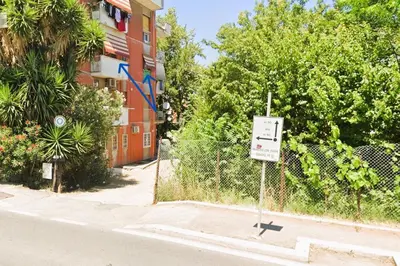 a sign on a fence in front of a building at Domus MT481 in Rome