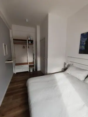 a bedroom with a large white bed and a closet at Domus MT481 in Rome