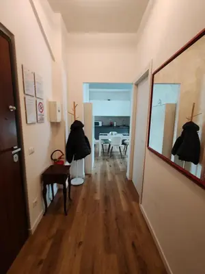 a hallway with two black dresses hanging on the wall at Domus MT481 in Rome