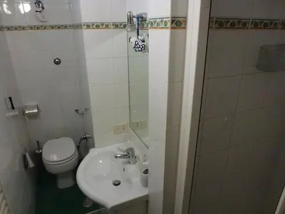 a small bathroom with a toilet and a sink at Vacanze al Colosseo Polveriera in Rome