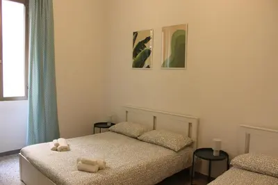 a bedroom with two beds with towels on them at Tiberim, Centro Storico in Rome