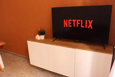 a television on top of a white cabinet at Tiberim, Centro Storico in Rome