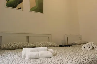 a bedroom with a bed with two towels on it at Tiberim, Centro Storico in Rome