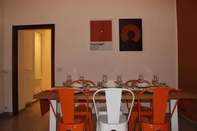 a dining room with a table and orange chairs at Tiberim, Centro Storico in Rome