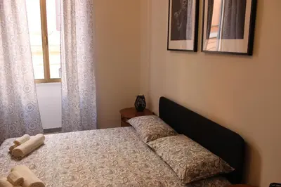 a bedroom with a bed and a window at Tiberim, Centro Storico in Rome