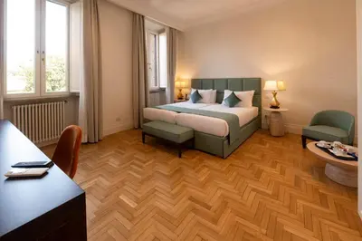 a hotel room with a bed and a desk at AGH Babuino in Rome