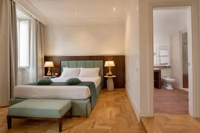 a bedroom with a large bed and a bathroom at AGH Babuino in Rome