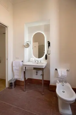 a bathroom with a sink and a toilet and a mirror at AGH Babuino in Rome