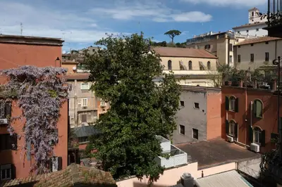 a tree in the middle of a city with buildings at AGH Babuino in Rome