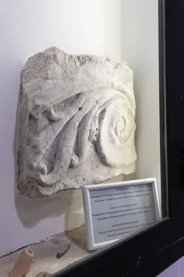 a stone artifact on display in a museum at Vatican Home in Rome