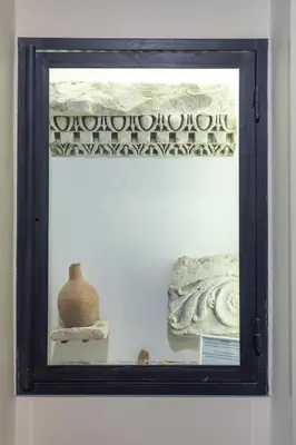 a mirror on a wall with a vase on a shelf at Vatican Home in Rome