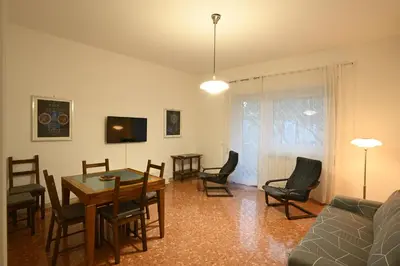 a living room with a couch and a table and chairs at Vatican Firefly House in Rome