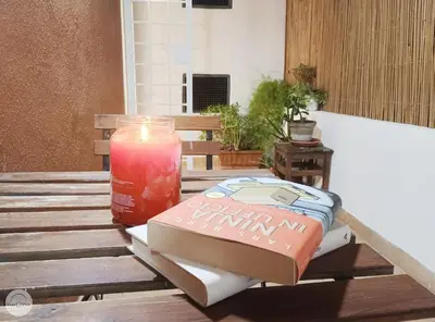 a candle sitting on a table next to a box at Pon Pon Sweet Home in Rome