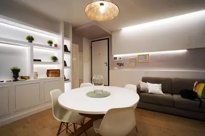a living room with a white table and a couch at Pon Pon Sweet Home in Rome