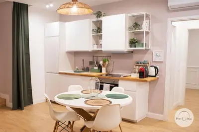 a small kitchen with a white table and chairs at Pon Pon Sweet Home in Rome
