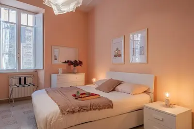 a bedroom with a bed with a tray of fruit on it at La Casetta di San Giovanni in Rome