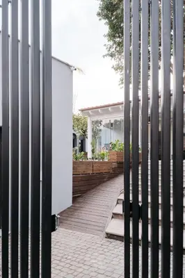 an external view of a house through a fence at Le Arcate, suite 1 Lavinia, suite 2 Lucilla in Rome