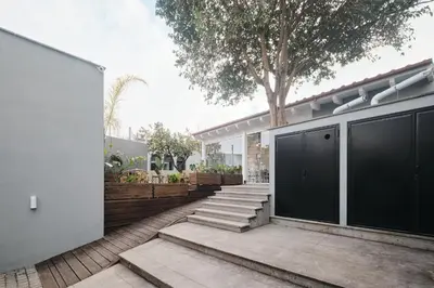 a house with black doors and stairs in front of it at Le Arcate, suite 1 Lavinia, suite 2 Lucilla in Rome
