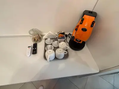 a table with an orange bag and items on it at Guest House Vatican Room da Gabry in Rome