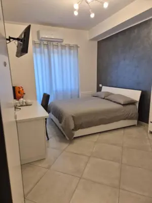 a bedroom with a bed with blue curtains and a desk at Guest House Vatican Room da Gabry in Rome