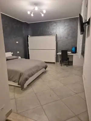 a bedroom with a bed and a table and a desk at Guest House Vatican Room da Gabry in Rome
