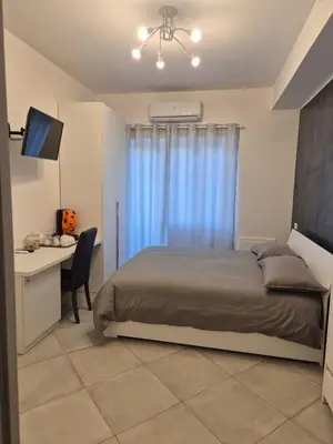 a bedroom with a bed and a desk with a computer at Guest House Vatican Room da Gabry in Rome