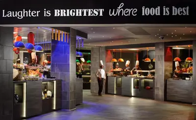 a man standing in a kitchen in a restaurant at A.Roma Lifestyle Hotel in Rome